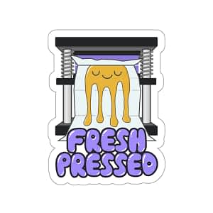 a purple and gold vinyl sticker of a happy cartoon dab of rosin being pressed into parchment which says fresh pressed